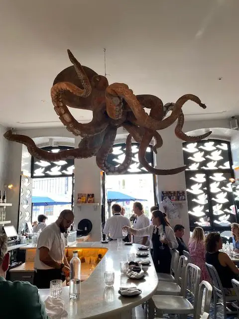 Giant octopus above the bar and chef's station at Lisbon's A Cevicheria resrestaurant.