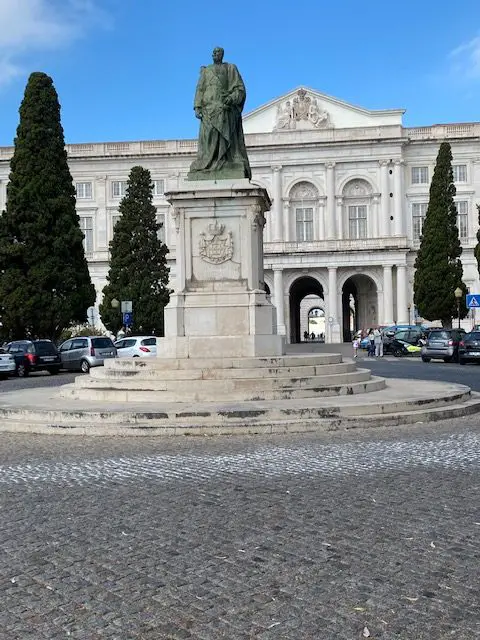 The exterior of Lisbon's Ajuda National Palace.  Carlos I, the last king to occupy the palace stands atop the statue in front of the palace.