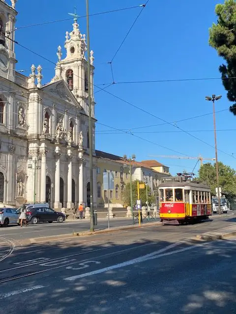 Tram 28 passing Lisbon's Basilica da Estrela