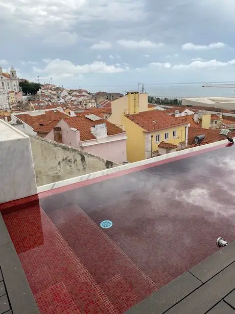 Red infinity pool on the roof of Lisbon's Memmo Alfama Hotel