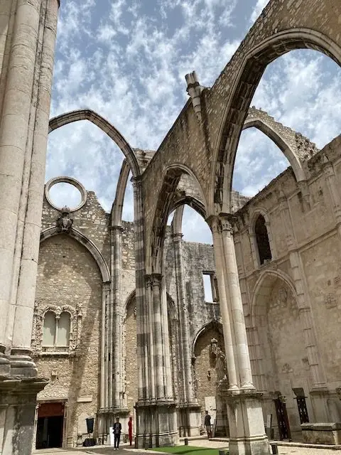 The arches of Lisbon's Convento do Carmo ruins framing the sky
