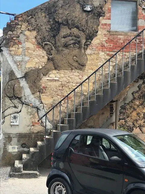Mural of big-hair guy running up the stairs at LX Factory, Lisbon