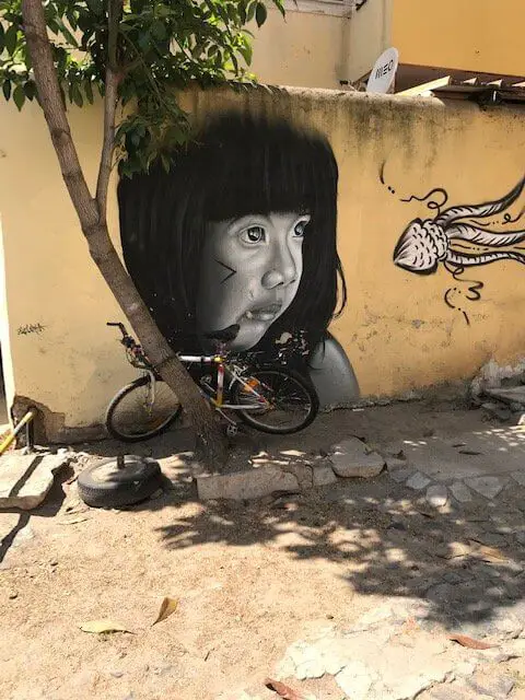 Very realistic portrait of little girl in black and white.  Mural at Lisbon's LX Factory