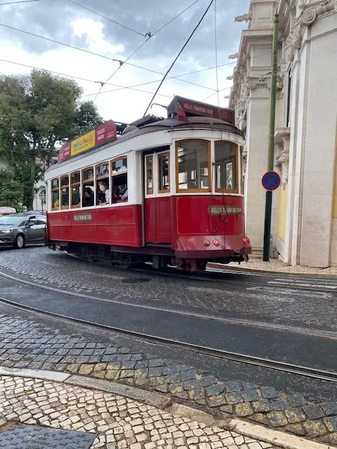 The red tram is a private tour and is an alternate to Lisbon's Tram 28E