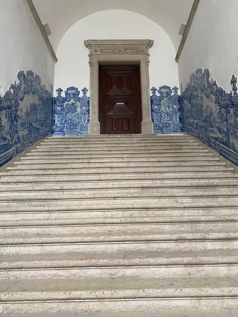 The staircases at Lisbon's São Vicente de Fora Monastery are decorated with blue and white azulejo tile panels