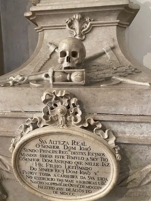 Tomb of one of the Meninos de Palhavã at Lisbon's São Vicente de Fora Monastery. The most notable feature of the tomb is the carved human skull on top.