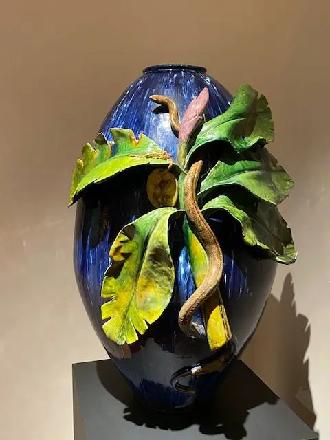 A serpent crawls up a branch on this blue vase created by Portuguese artist Rafael Bordalo Pinheiro.  The vase is part of the Berardo Art Deco Collection in Lisbon, Portugal