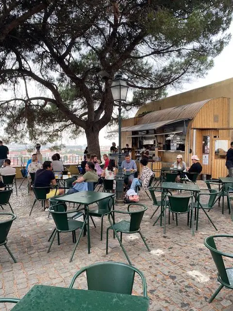 The pine shaded kiosk at Lisbon's Miradouro da Graça has 30 or 40 tables