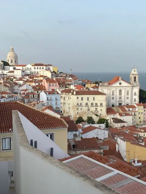 View of the dome of the National Pantheon and Santo Estevao church in Lisbon from the Miradouro de Santa Luzia over the Alfama neighborhood