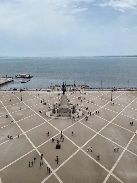 Looking down on the diamond patterned mosaic of Lisbon's Praca do Comercio, with its central sculpture of King Jose I overlooking the Tejo River