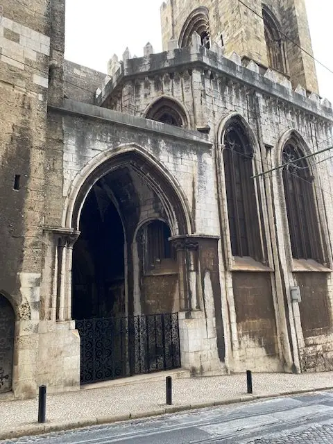 A side door of the Lisbon Cathedral.  Classic Gothic arches shape the doors and windows on this side of the church