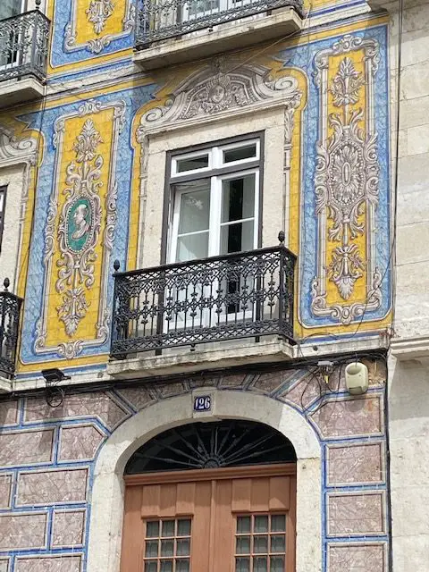 Close-up of blue, yellow, white tiled façade at Campo de Santa Clara, 126, Lisbon