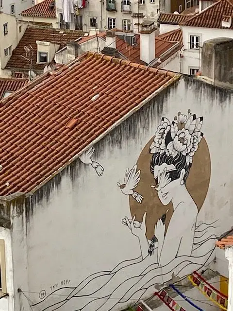 Mural "Lisa" by Brasilian artist Tami Hopf at Portas do Sol viewpoint in Lisbon's Alfama neighborhood