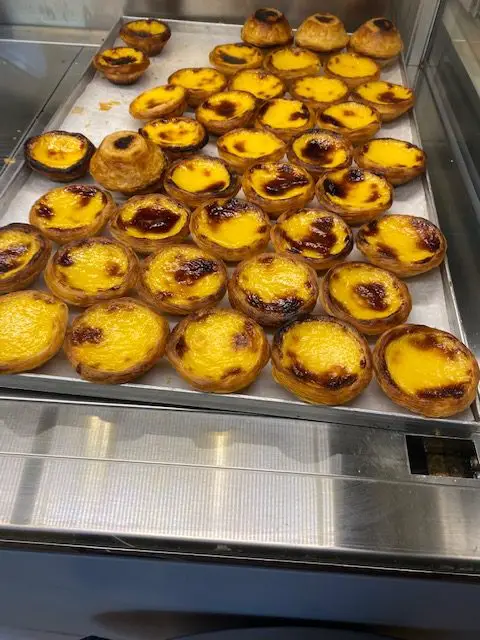 Fresh pastéis de nata (Portuguese custard tarts) at the award-winning bakery, Pastelaria de Santo António, near Lisbon's Castelo de São Jorge.
