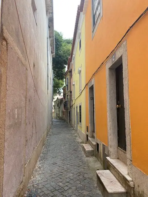 Lisbon's Alfama was built way before the age of the automobile.  Streets are often narrow, and the houses often have very small doors