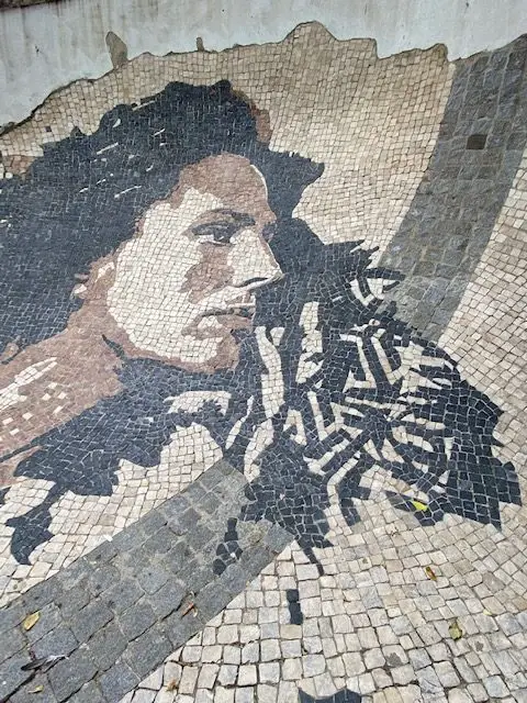 Black and white cobblestone portrait of Fado star Amália Rodrigues created by artist Vhils and the calçeteiros  (pavers) of Lisbon.
