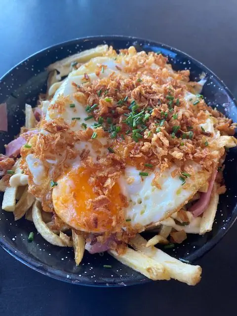 Eggs, bacon, carmelized onions, french fries at Madame Petisca Rooftop bar in Lisbon, Portugal