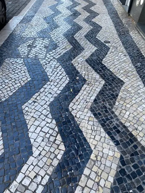 Zig zag pattern of black and white cobblestones near Campo Pequeno in Lisbon