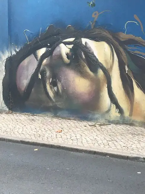 A portrait on Lisbon's Blue Wall homoring mental health issues and treatment