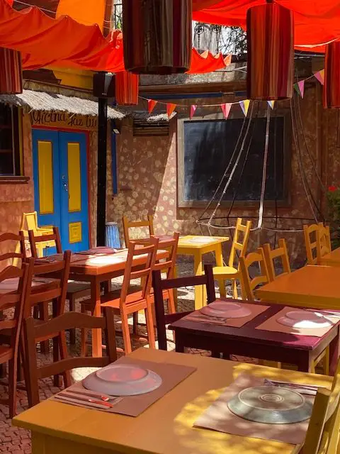 Lisbon's quirky restaurant Chapito a Mesa is a splash of color - different colored tables, walls, and ceiling.