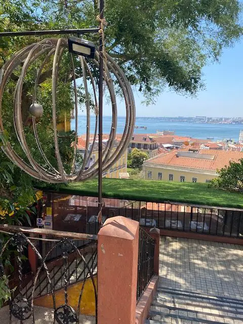 Creatively decorated stairwell witha view of the Tejo River leading down to Lisbon's Chapito a Mesa restaurant.