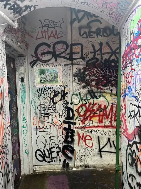 The door on the left in this graffiti covered stairwell is the entrance to Lisbon's unusual secret Chinese restaurant