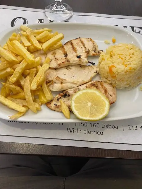 Grilled chicken, french fries, and rice are an option for O Prato do Dia (the daily special) at O Marquez, a restaurant that is popular among Lisbon's locals