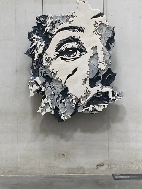 Marble carving, Petra, created by Vhils, in 2020 hangs at the Museu Nacional dos Coches in Lisbon, Portugal