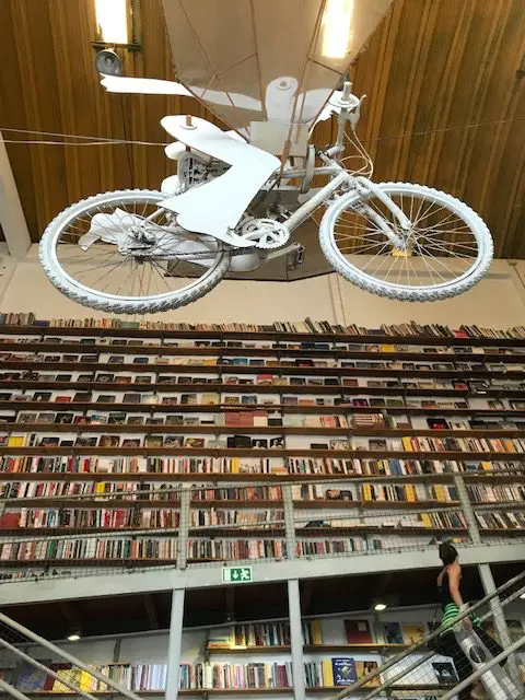 Bicycle suspended from the ceiling in Lisbon's Livraria Ler Devagar bookstore, located in the LX Factory