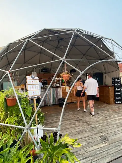 The poolside bar at Lisbon's Sunset Destination Hostel is located on the roof of the Cais do Sodré Train Station.  The bar sits inside of a geodesic dome structure.