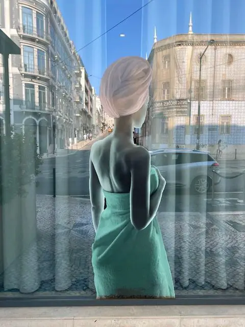 Lisbon's Avenida Almirante Reis is reflected in the window of the WC Hotel