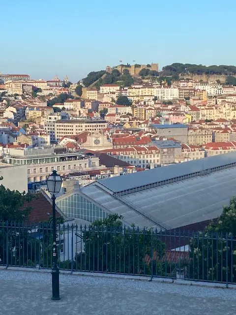 Lisbon's hilltop São Jorge Castle seen from the São Pedro de Alcântara viewpoint on the opposing hilltop