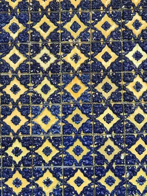 Symetrical blue and white diamond azulejo tile mosaic on display at the National Tile Museum in Lisbon, Portugal